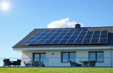 Contemporary house with solar panels installed on a south-facing roof, illustrating sustainable energy use.