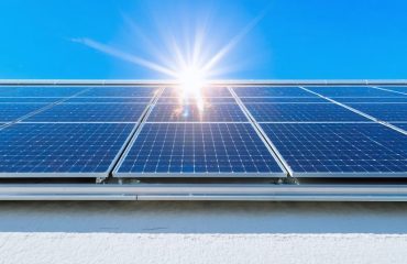 Solar panels installed on a modern rooftop under a clear blue sky, exemplifying the efficient conversion of sunlight into clean, sustainable energy for a radiant home.