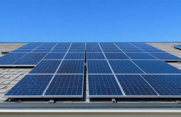 Residential home with solar panels on the roof highlighting Xcel Energy’s solar power solutions under a sunny sky