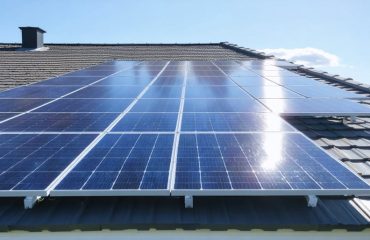 Rooftop solar panels shining in the sunlight, representing efficient, well-maintained systems for optimal energy production.