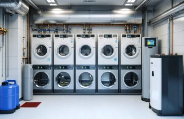 A modern home utility room with lithium-ion battery storage units mounted, showcasing temperature gauges and digital monitoring displays, highlighting safe storage practices.