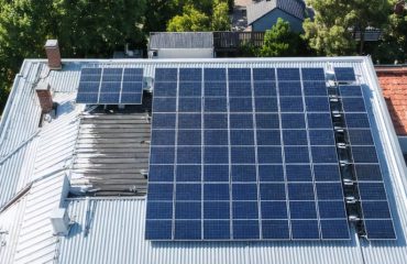 Conceptual illustration of a residential rooftop with solar panels, displaying setback measurements and clear pathways essential for fire safety and compliance.